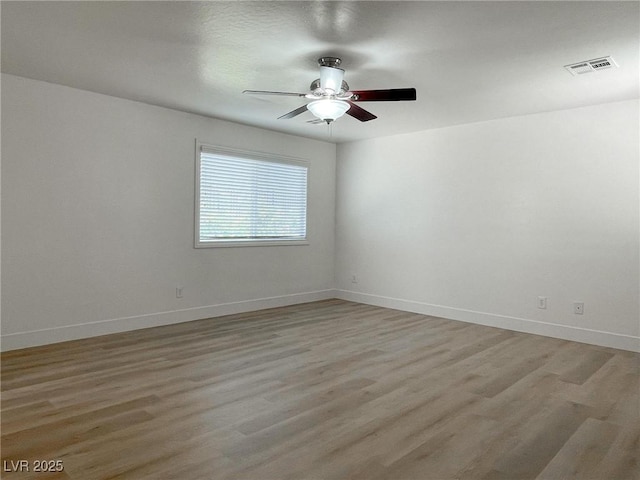 spare room featuring hardwood / wood-style flooring and ceiling fan