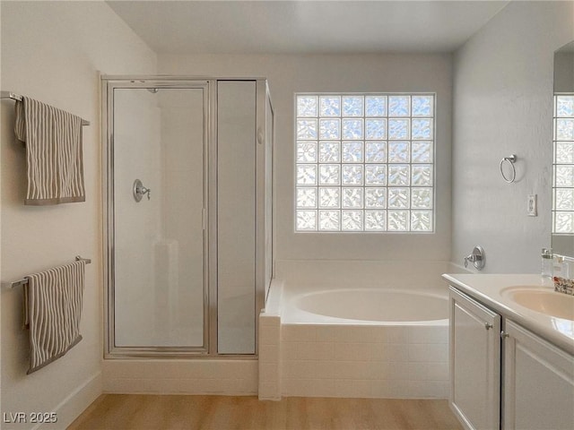 bathroom with vanity, separate shower and tub, and wood-type flooring