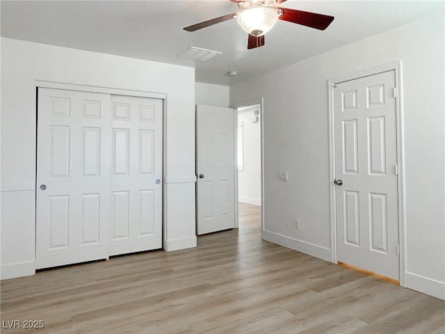 unfurnished bedroom with ceiling fan and light wood-type flooring