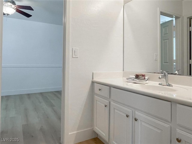 bathroom with ceiling fan, vanity, and hardwood / wood-style floors