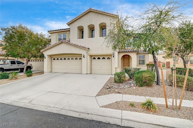 mediterranean / spanish house with a garage