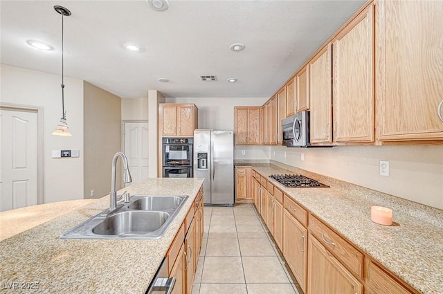 kitchen featuring sink, decorative light fixtures, light brown cabinets, and appliances with stainless steel finishes