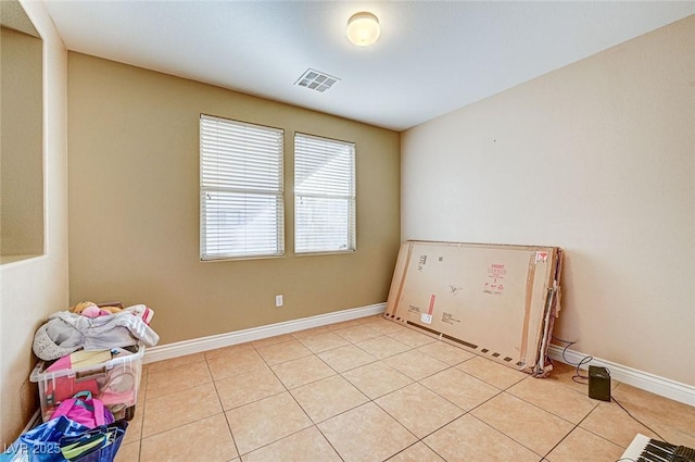 unfurnished room featuring light tile patterned floors