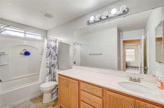 full bathroom featuring vanity, shower / bath combo, and toilet