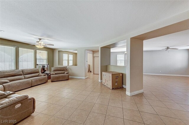 tiled living room featuring a textured ceiling and ceiling fan