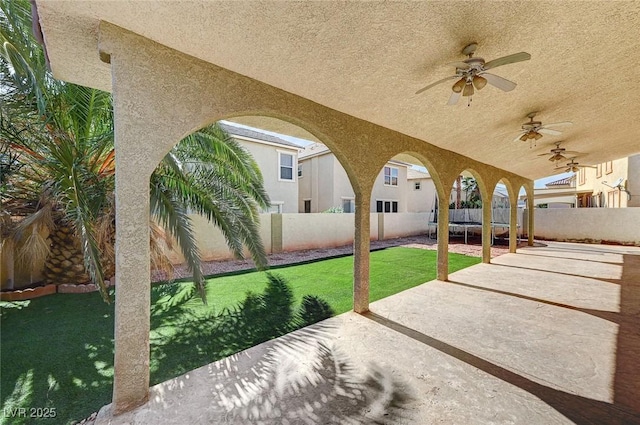 view of patio featuring ceiling fan and a trampoline