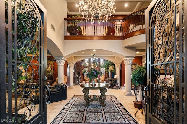609 China Doll Pl, Henderson, NV 89012 - entryway with a high ceiling, crown molding, and decorative columns