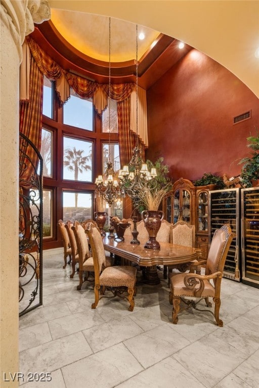 609 China Doll Pl, Henderson, NV 89012 - dining room featuring a notable chandelier, a tray ceiling, and a high ceiling