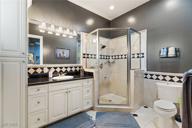 609 China Doll Pl, Henderson, NV 89012 - bathroom with toilet, tile walls, vanity, and walk in shower