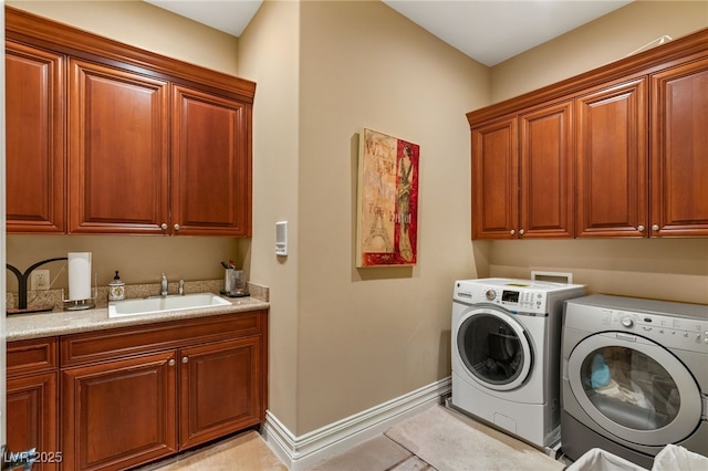 609 China Doll Pl, Henderson, NV 89012 - clothes washing area with cabinets, washer and clothes dryer, sink, and light tile patterned floors