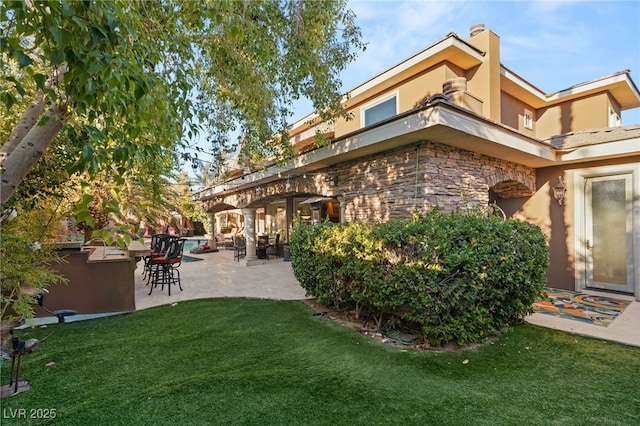 609 China Doll Pl, Henderson, NV 89012 - back of house featuring a patio area and a lawn