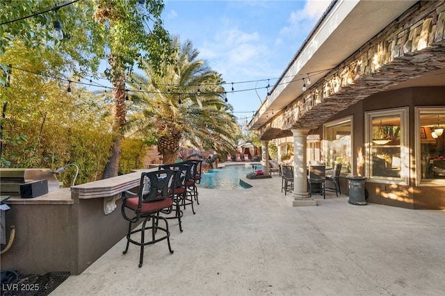 609 China Doll Pl, Henderson, NV 89012 - view of patio with an outdoor bar and an outdoor kitchen