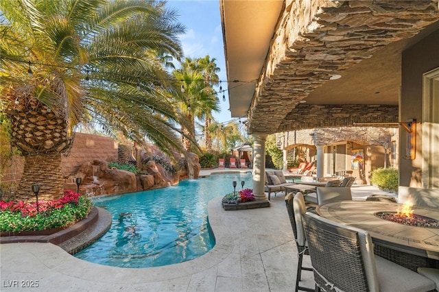 609 China Doll Pl, Henderson, NV 89012 - view of swimming pool with pool water feature, an outdoor fire pit, and a patio area