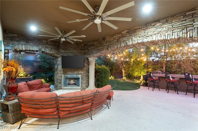 609 China Doll Pl, Henderson, NV 89012 - view of patio / terrace with exterior bar, an outdoor living space with a fireplace, and ceiling fan