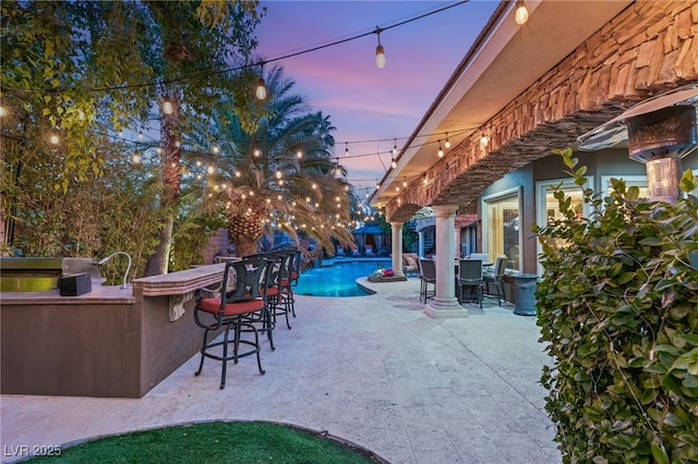 609 China Doll Pl, Henderson, NV 89012 - patio terrace at dusk with area for grilling and exterior bar