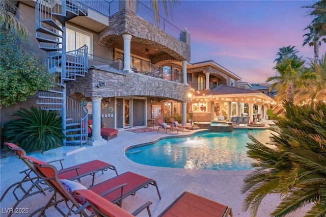 609 China Doll Pl, Henderson, NV 89012 - pool at dusk with a patio area and an in ground hot tub