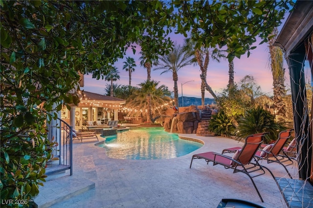 609 China Doll Pl, Henderson, NV 89012 - pool at dusk featuring a patio and an in ground hot tub