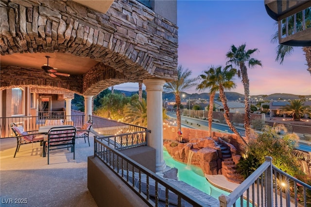 609 China Doll Pl, Henderson, NV 89012 - patio terrace at dusk with a mountain view, outdoor lounge area, and ceiling fan