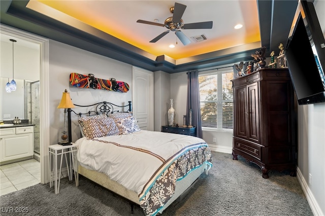609 China Doll Pl, Henderson, NV 89012 - carpeted bedroom featuring connected bathroom, a tray ceiling, and ceiling fan