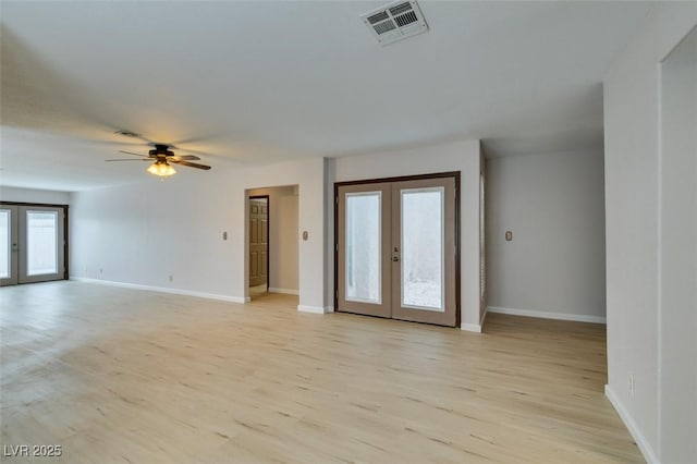 unfurnished room with french doors, ceiling fan, and light wood-type flooring