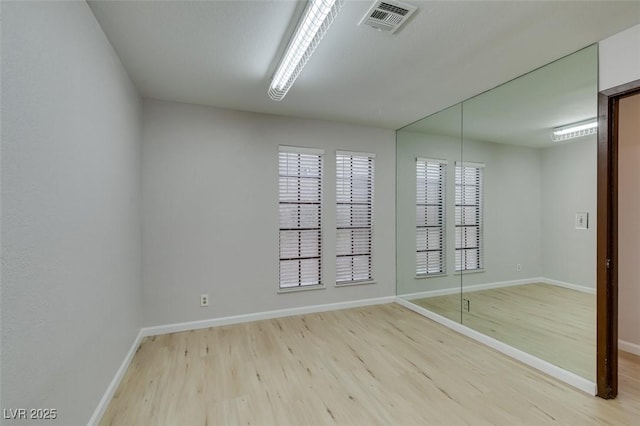 empty room with light hardwood / wood-style flooring