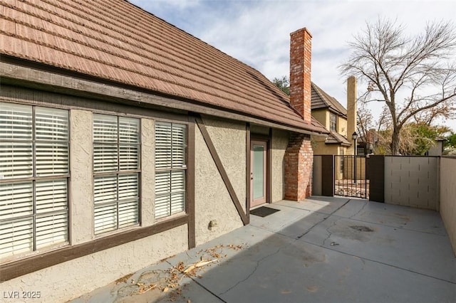 view of side of property with a patio