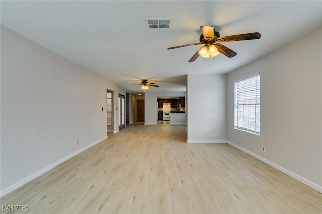 unfurnished living room featuring ceiling fan and light wood-type flooring