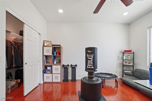 sitting room with ceiling fan and wood-type flooring