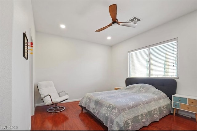 bedroom with ceiling fan and dark hardwood / wood-style flooring