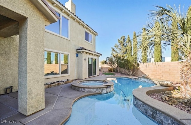 view of swimming pool with an in ground hot tub