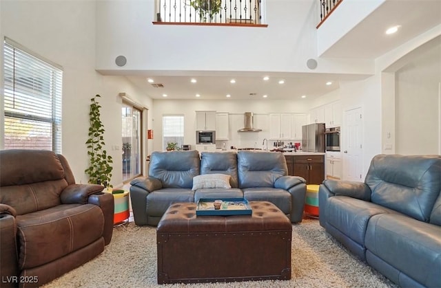 living room with light colored carpet and a high ceiling