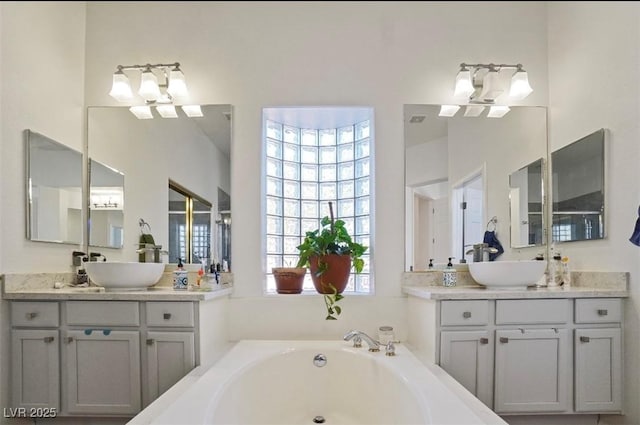 bathroom with vanity and a tub