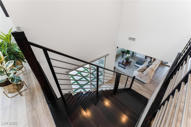 staircase with hardwood / wood-style floors