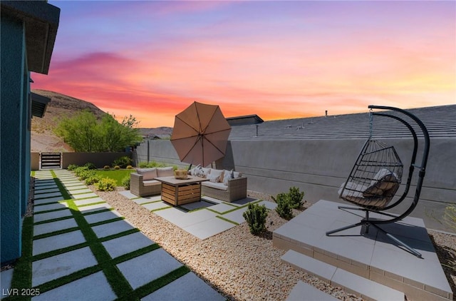 patio terrace at dusk featuring an outdoor living space