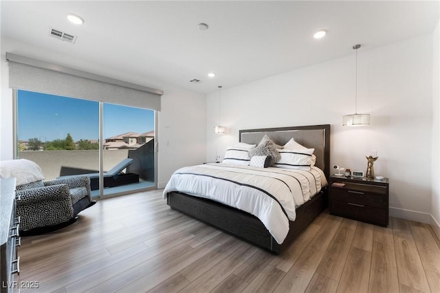 bedroom featuring access to outside and light hardwood / wood-style flooring