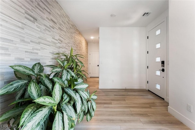 hallway with light hardwood / wood-style floors