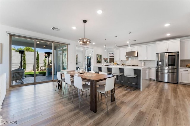 dining space with light hardwood / wood-style flooring