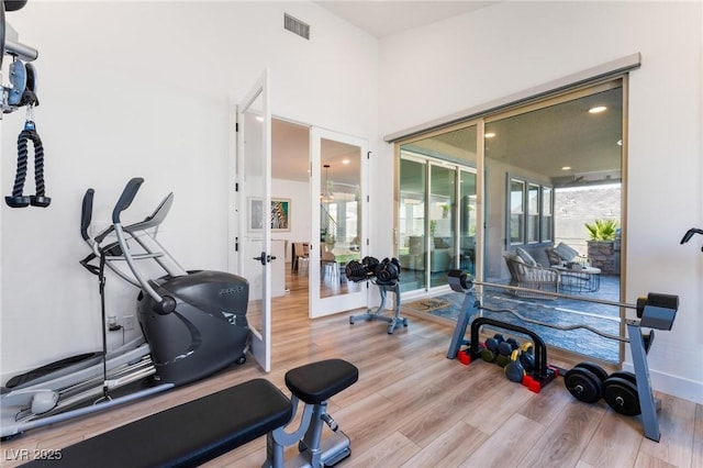 exercise room with light wood-type flooring