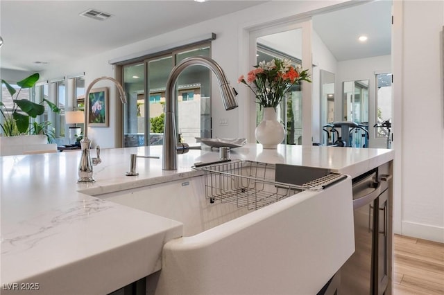 kitchen with sink and light hardwood / wood-style flooring