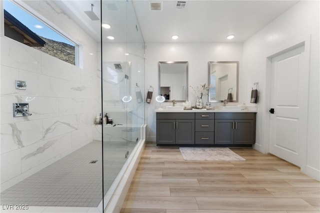 bathroom featuring vanity and a tile shower