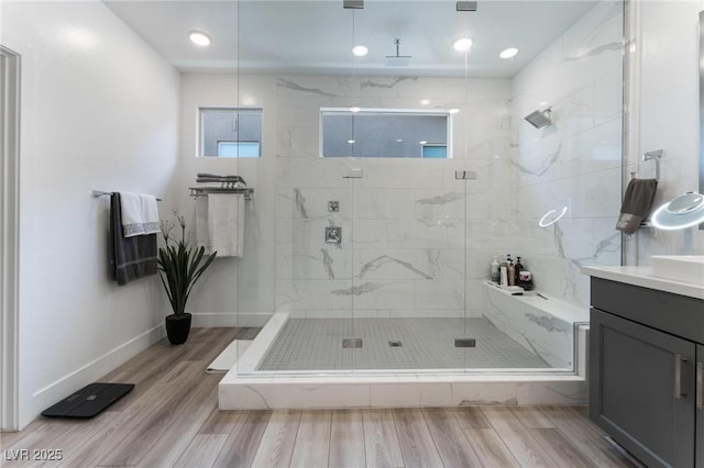 bathroom featuring vanity and a shower with door