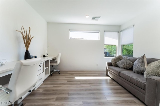 office area featuring wood-type flooring and built in desk