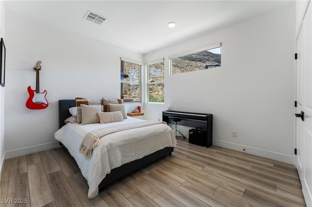 bedroom with hardwood / wood-style flooring