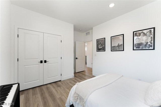 bedroom with a closet and light hardwood / wood-style flooring