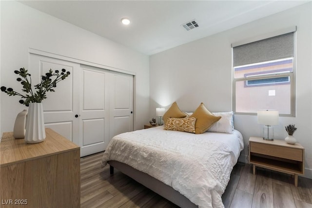 bedroom featuring dark hardwood / wood-style flooring and a closet