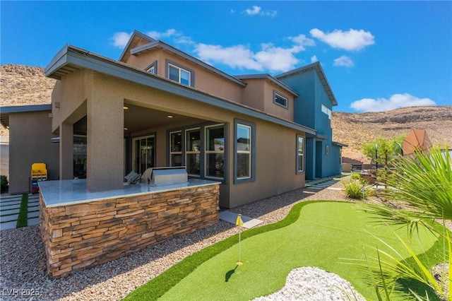 rear view of house featuring a patio area