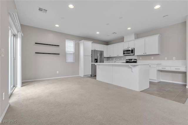 kitchen with light carpet, appliances with stainless steel finishes, visible vents, and recessed lighting