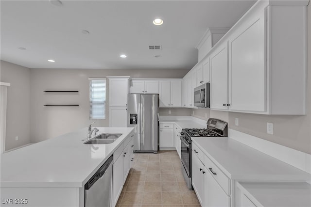 kitchen featuring visible vents, appliances with stainless steel finishes, white cabinetry, a sink, and recessed lighting