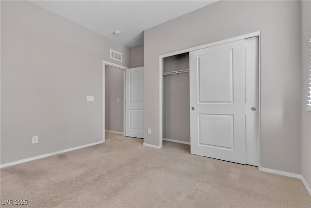 unfurnished bedroom with a closet, visible vents, and baseboards