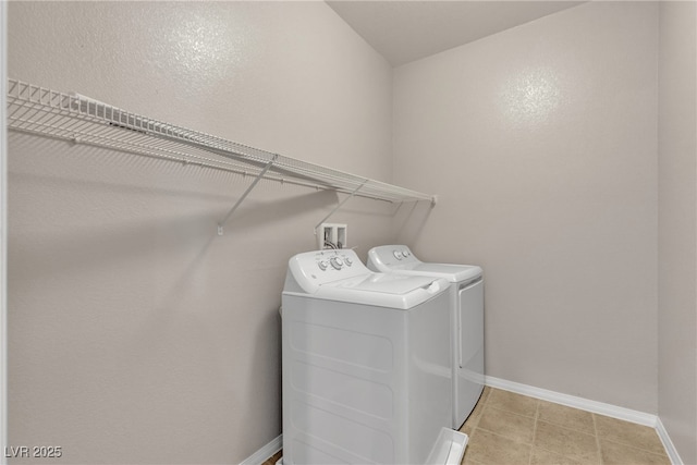 laundry area featuring laundry area, separate washer and dryer, and baseboards